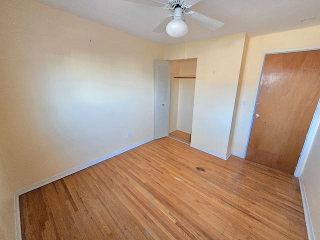 unfurnished bedroom featuring light hardwood / wood-style floors, ceiling fan, and a closet