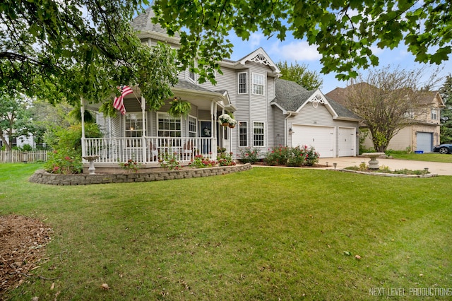 view of front of house with a porch, a front yard, and a garage