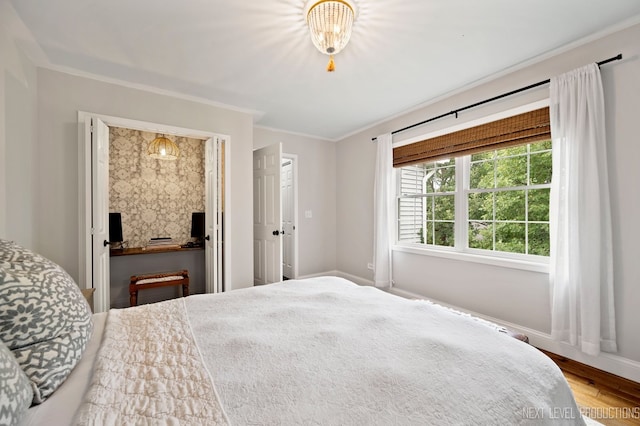 bedroom featuring hardwood / wood-style flooring and crown molding