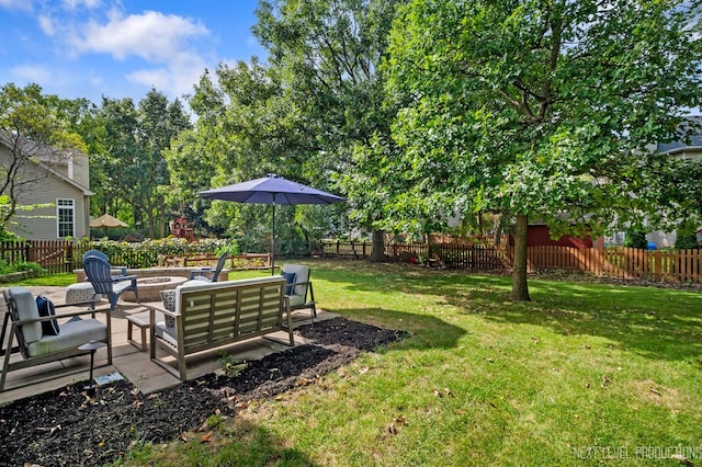 view of yard with a patio and an outdoor living space with a fire pit