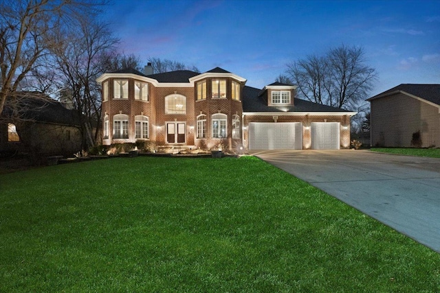 view of front facade featuring a lawn and a garage