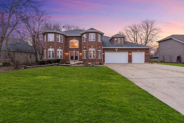 view of front facade featuring a garage and a lawn