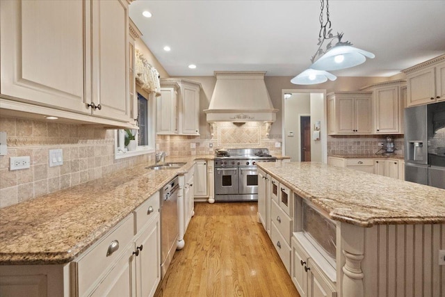 kitchen featuring sink, pendant lighting, a kitchen island, custom exhaust hood, and appliances with stainless steel finishes