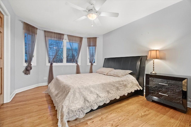 bedroom featuring hardwood / wood-style floors and ceiling fan