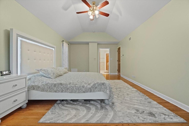 bedroom featuring ceiling fan, light hardwood / wood-style floors, and vaulted ceiling