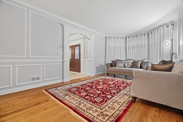 living room featuring hardwood / wood-style floors and ornamental molding