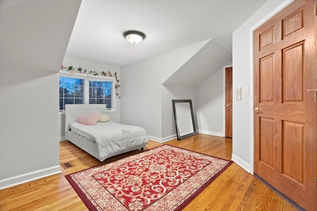 bedroom with hardwood / wood-style floors