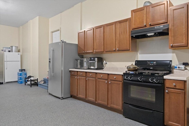 kitchen featuring white refrigerator, stainless steel fridge with ice dispenser, and black gas range oven