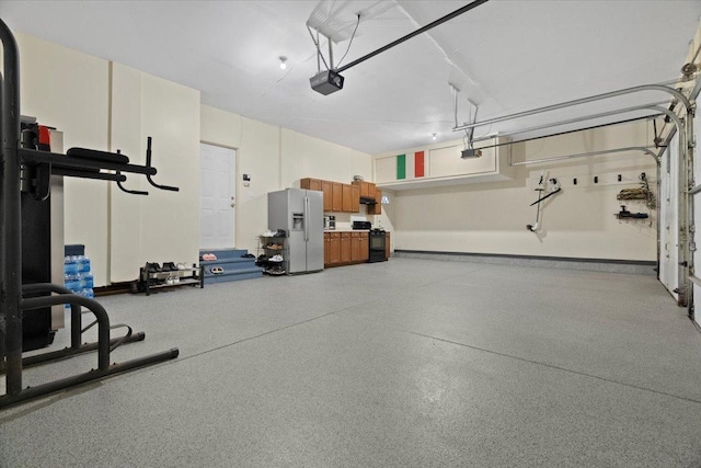 garage featuring white fridge with ice dispenser and a garage door opener