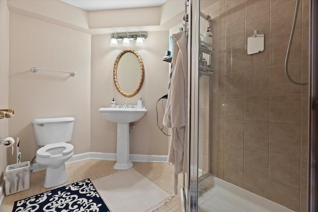 bathroom with tile patterned floors, toilet, and walk in shower