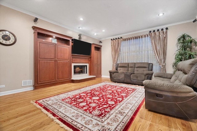 living room with wood-type flooring and crown molding