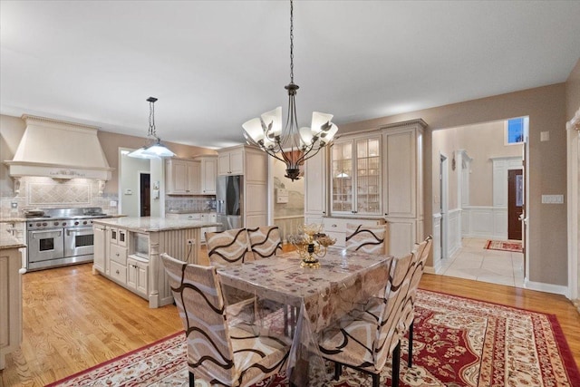 dining room featuring a notable chandelier and light hardwood / wood-style floors