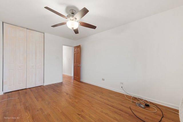 unfurnished bedroom with a closet, ceiling fan, and light hardwood / wood-style flooring