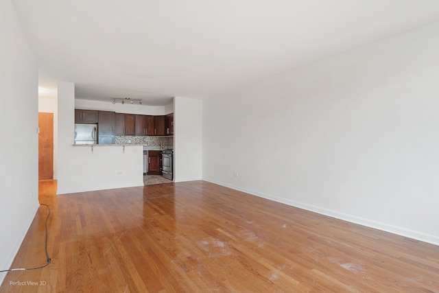 unfurnished living room with light hardwood / wood-style flooring