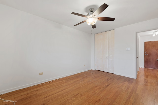 unfurnished bedroom with a closet, light hardwood / wood-style flooring, and ceiling fan