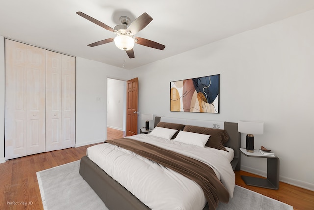 bedroom with a closet, ceiling fan, and hardwood / wood-style floors