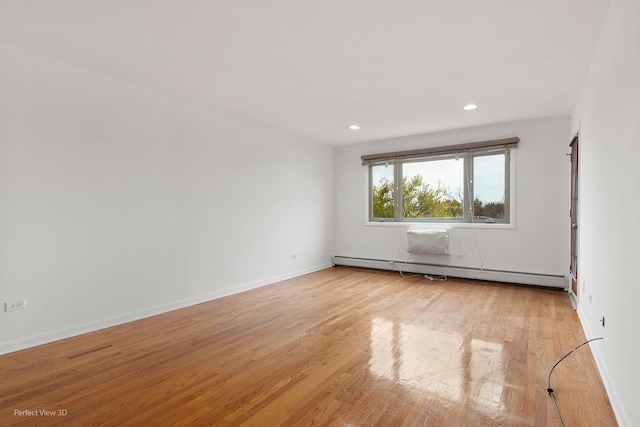 unfurnished room featuring light wood-type flooring and a baseboard radiator