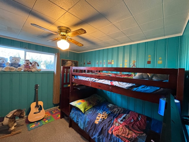 carpeted bedroom with ceiling fan and crown molding