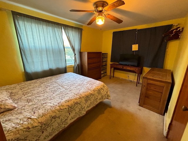 bedroom with ceiling fan and light carpet