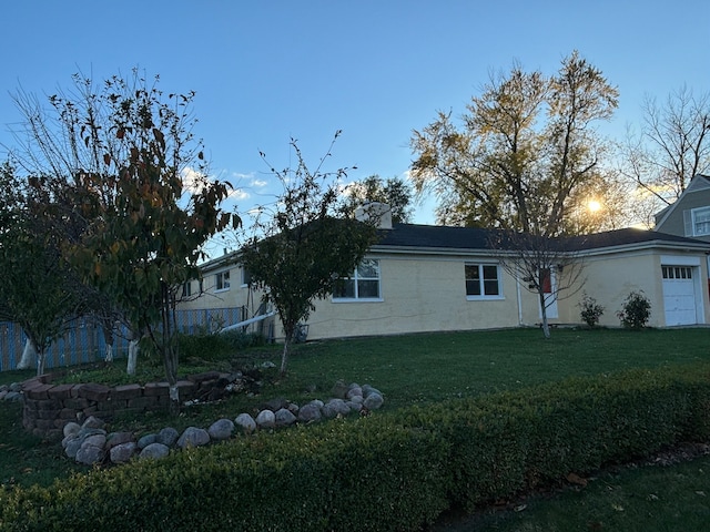 view of property exterior with a lawn and a garage