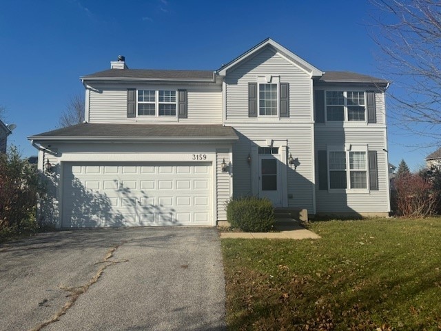 view of front of property with a garage and a front yard