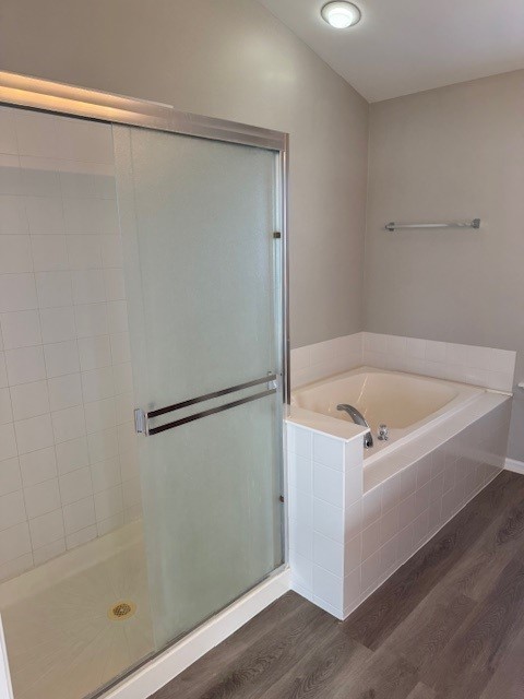 bathroom featuring independent shower and bath and hardwood / wood-style floors