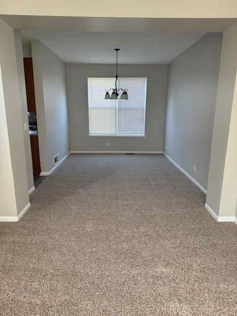 unfurnished dining area with carpet floors and a notable chandelier