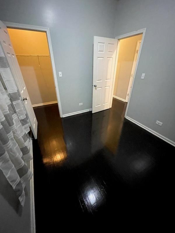 spare room with dark hardwood / wood-style floors