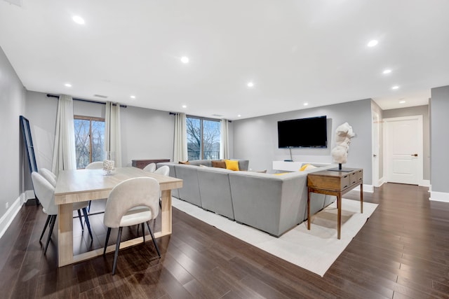 living room featuring dark hardwood / wood-style flooring and plenty of natural light