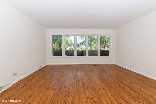 unfurnished room with wood-type flooring