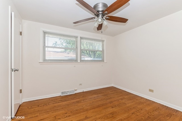 empty room with ceiling fan and hardwood / wood-style flooring