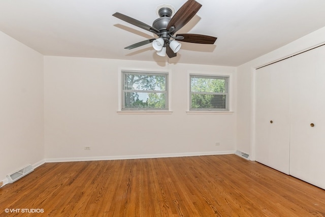 unfurnished bedroom featuring ceiling fan, a closet, and light hardwood / wood-style floors