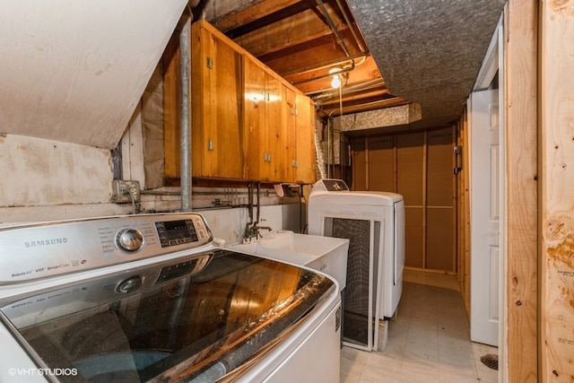 clothes washing area with washer and dryer and sink