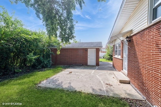 view of patio featuring an outbuilding