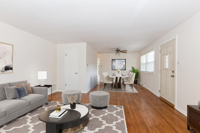 interior space with ceiling fan and wood-type flooring