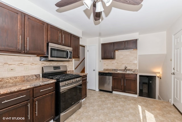 kitchen featuring tasteful backsplash, dark brown cabinetry, stainless steel appliances, ceiling fan, and sink