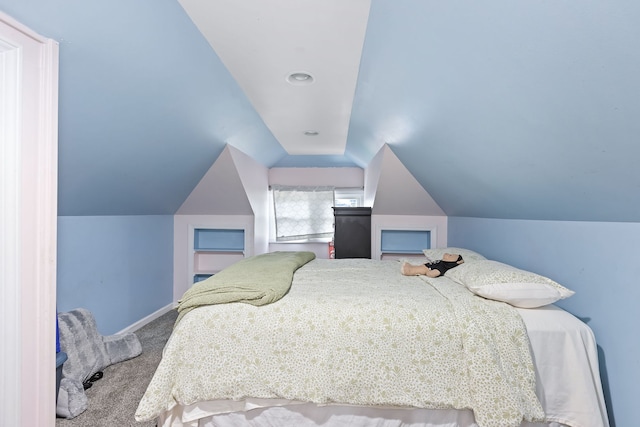 bedroom with carpet flooring and lofted ceiling