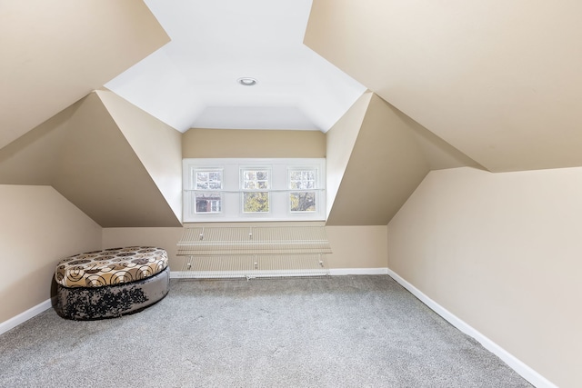 bonus room with lofted ceiling and carpet floors