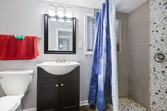 bathroom featuring walk in shower, vanity, and toilet