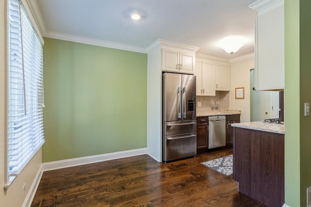 kitchen with crown molding, white cabinetry, stainless steel appliances, and dark brown cabinets