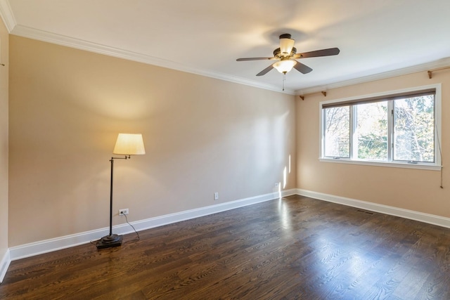 unfurnished room with dark wood-style floors, ornamental molding, baseboards, and a ceiling fan