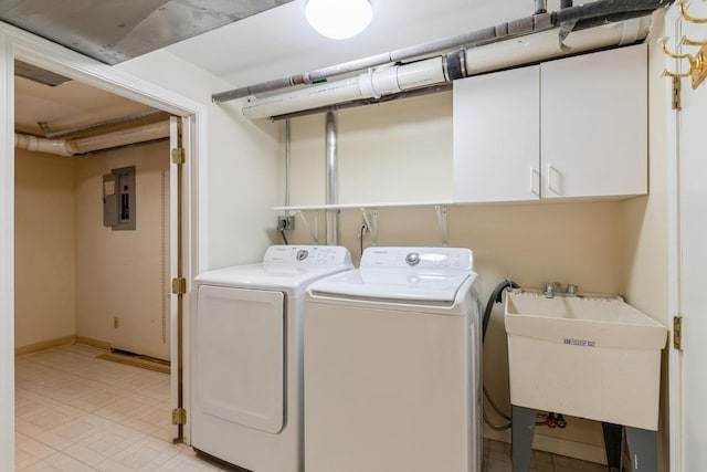 clothes washing area with electric panel, cabinet space, a sink, and washer and clothes dryer