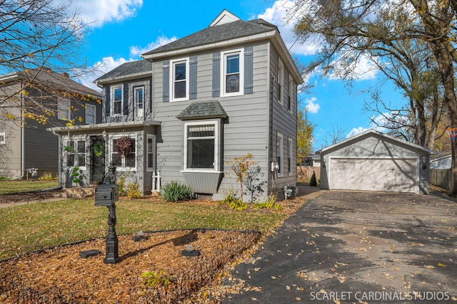 front of property with a garage, an outbuilding, and a front yard