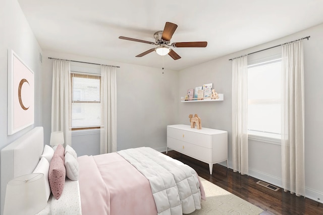 bedroom with dark hardwood / wood-style floors and ceiling fan