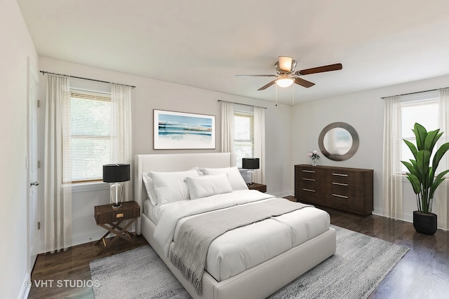 bedroom with multiple windows, ceiling fan, and dark hardwood / wood-style floors