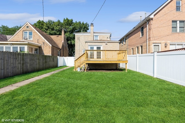 back of house featuring a lawn and a deck