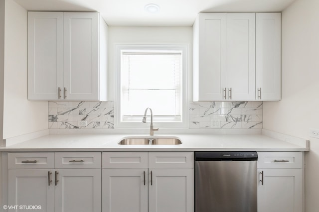 kitchen featuring dishwasher, decorative backsplash, white cabinets, and sink