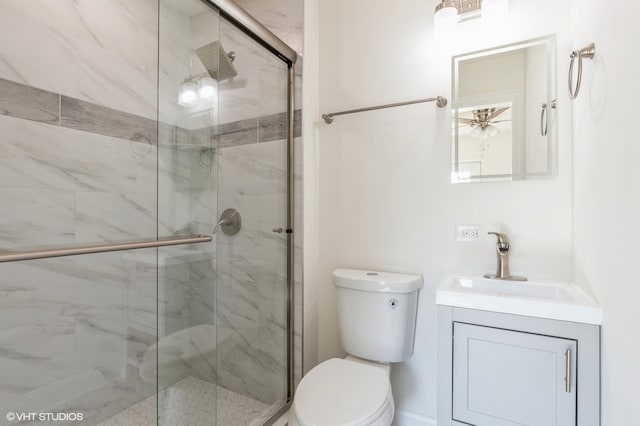 bathroom with vanity, toilet, and a shower with door