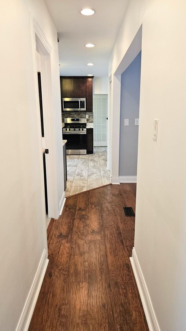 corridor with light wood-type flooring