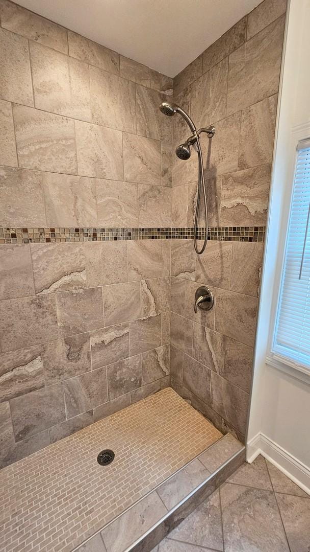 bathroom with a tile shower